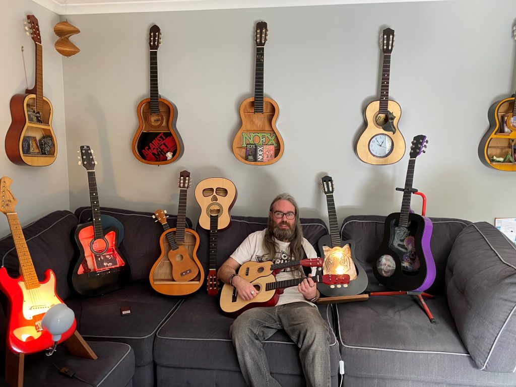 Paul-with-guitars-sitting-on-